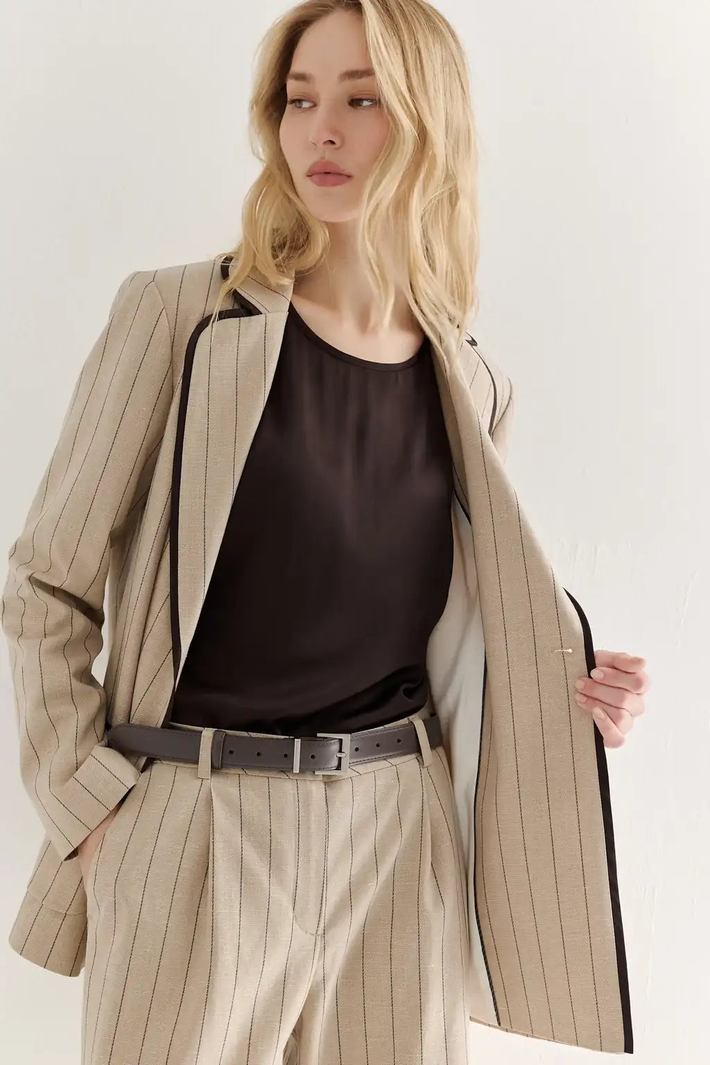AYRA Sand Piped Safari Blazer in sand melange lyocell-linen blend with contrasting dark striped piping
