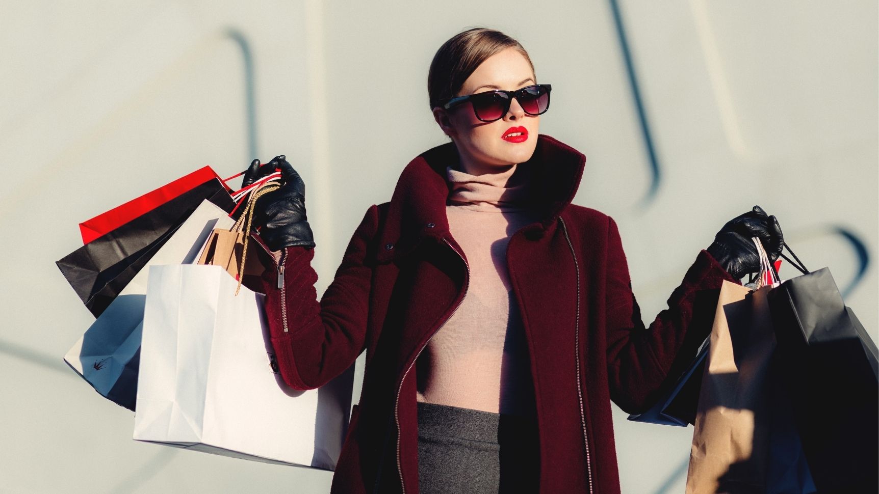 beautiful woman with red lipstick wearing red overcoat wearing AYRA