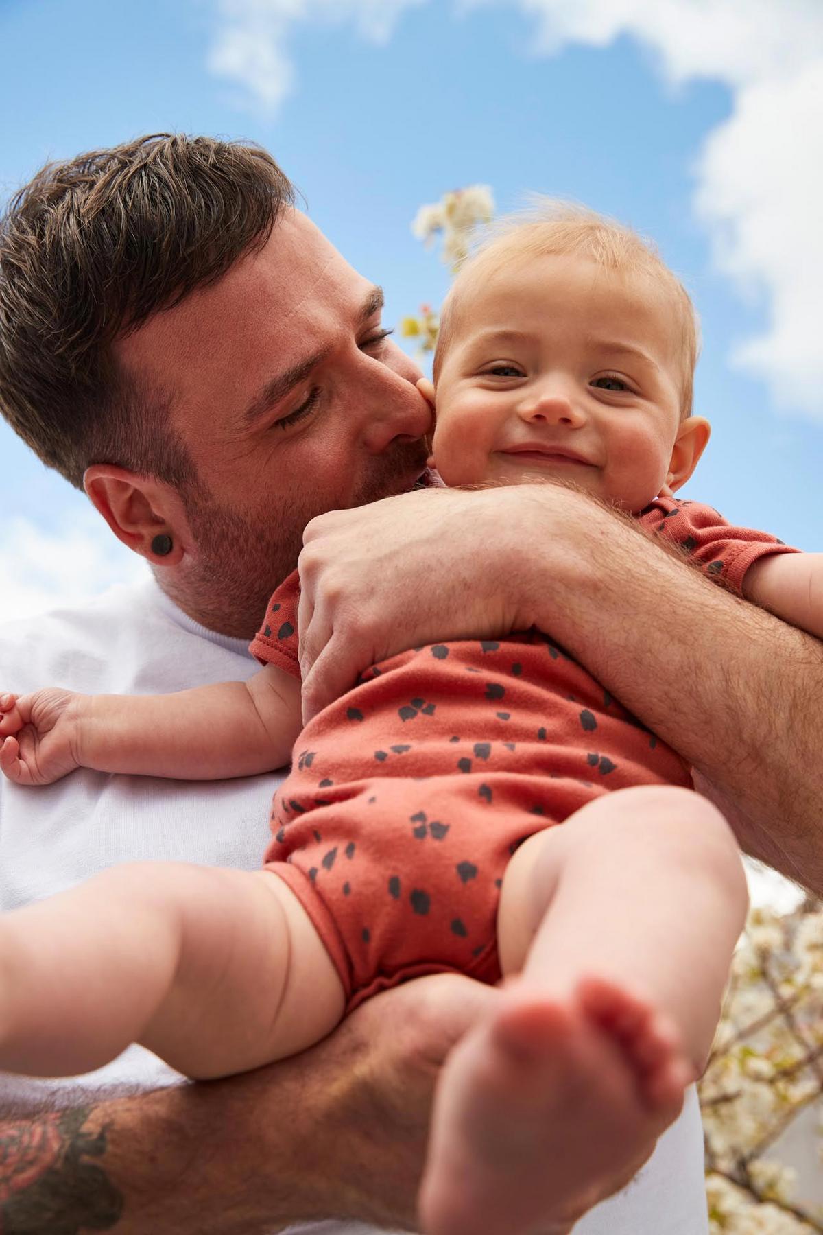 handsome man holding his cute little baby