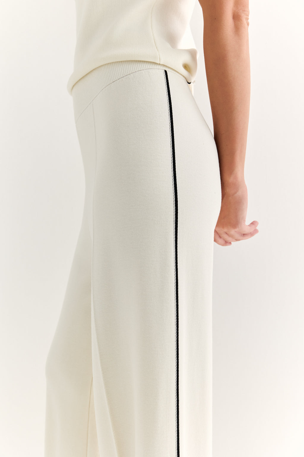 White pants with a black stripe on a white background