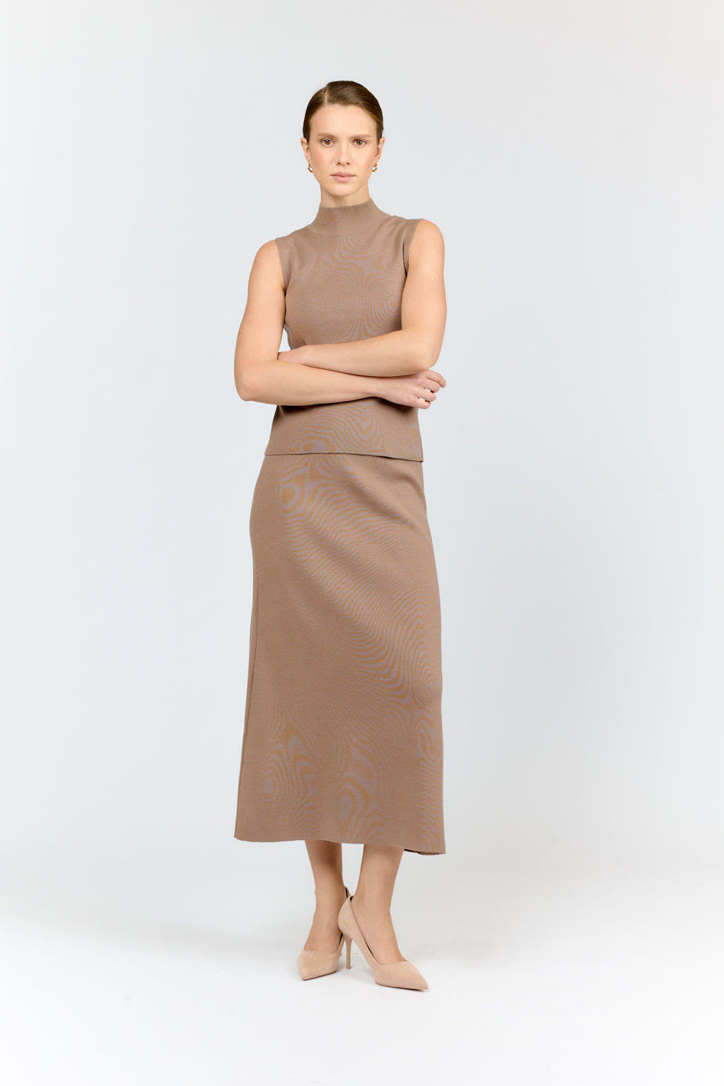 Woman wearing a brown sleeveless dress on a white background
