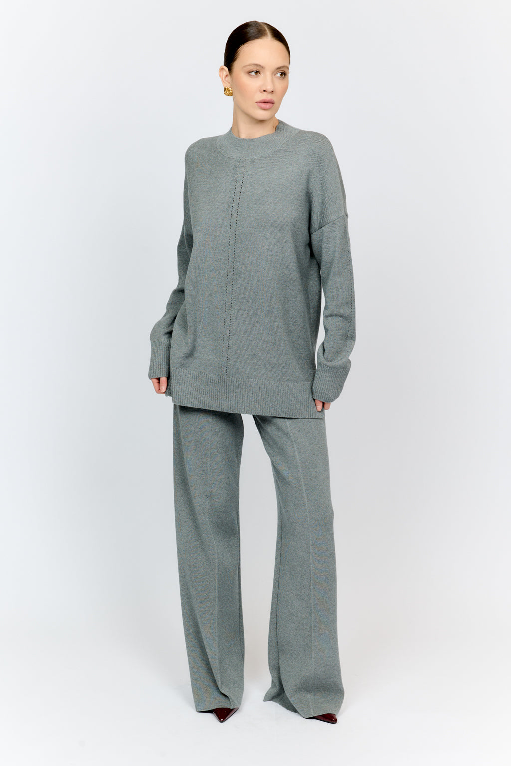 Woman wearing a gray outfit on a white background