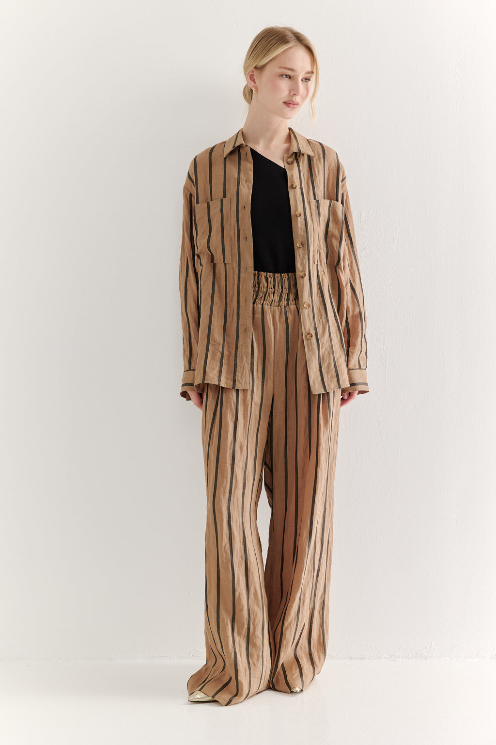 Woman wearing a striped suit on a white background