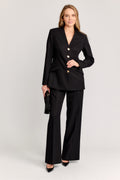 Woman wearing a black suit with a white background