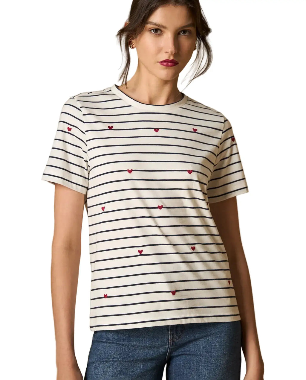 Woman wearing AYRA off-white and navy striped short-sleeved t-shirt with delicate red heart embroidery