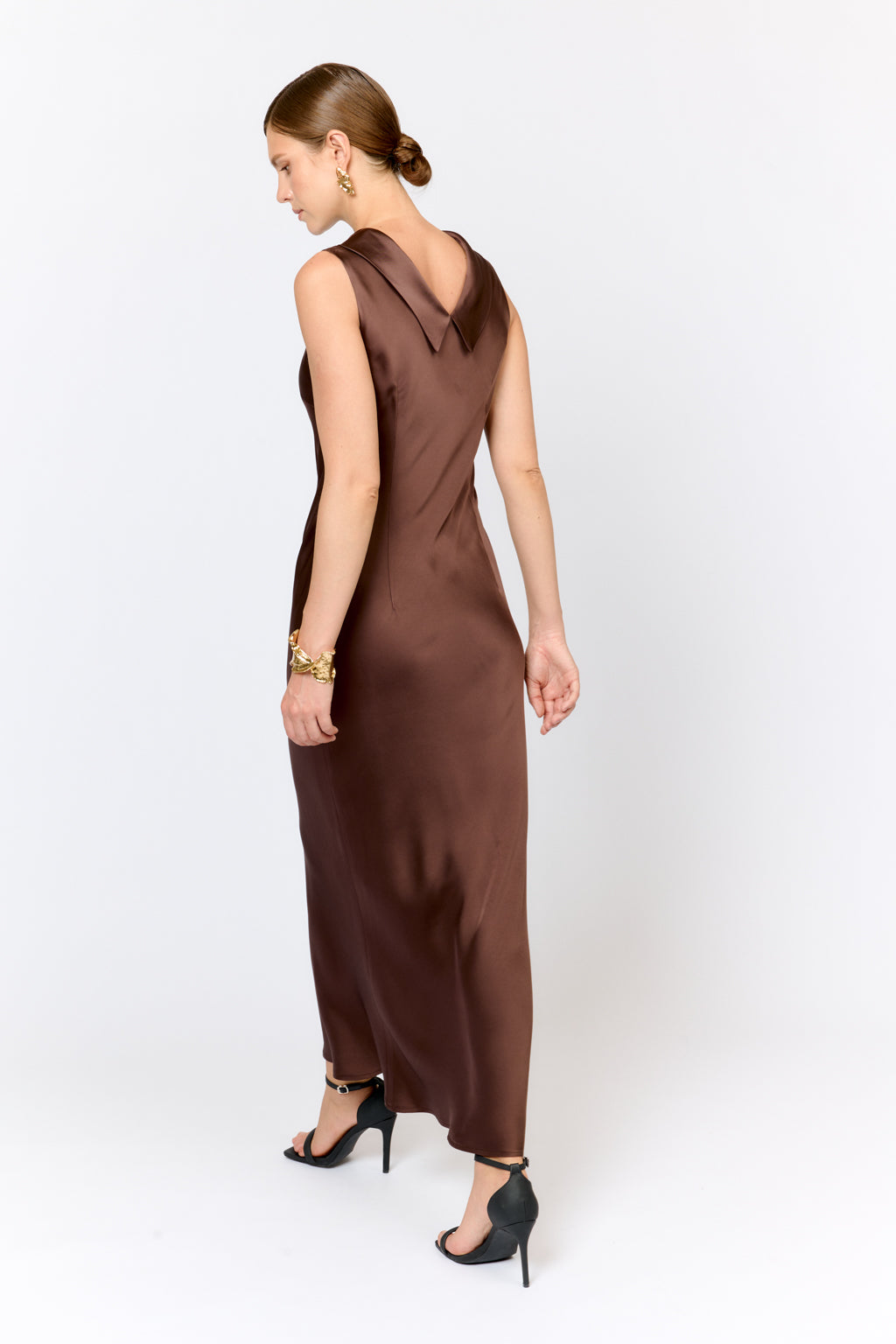 Woman wearing a brown dress on a white background