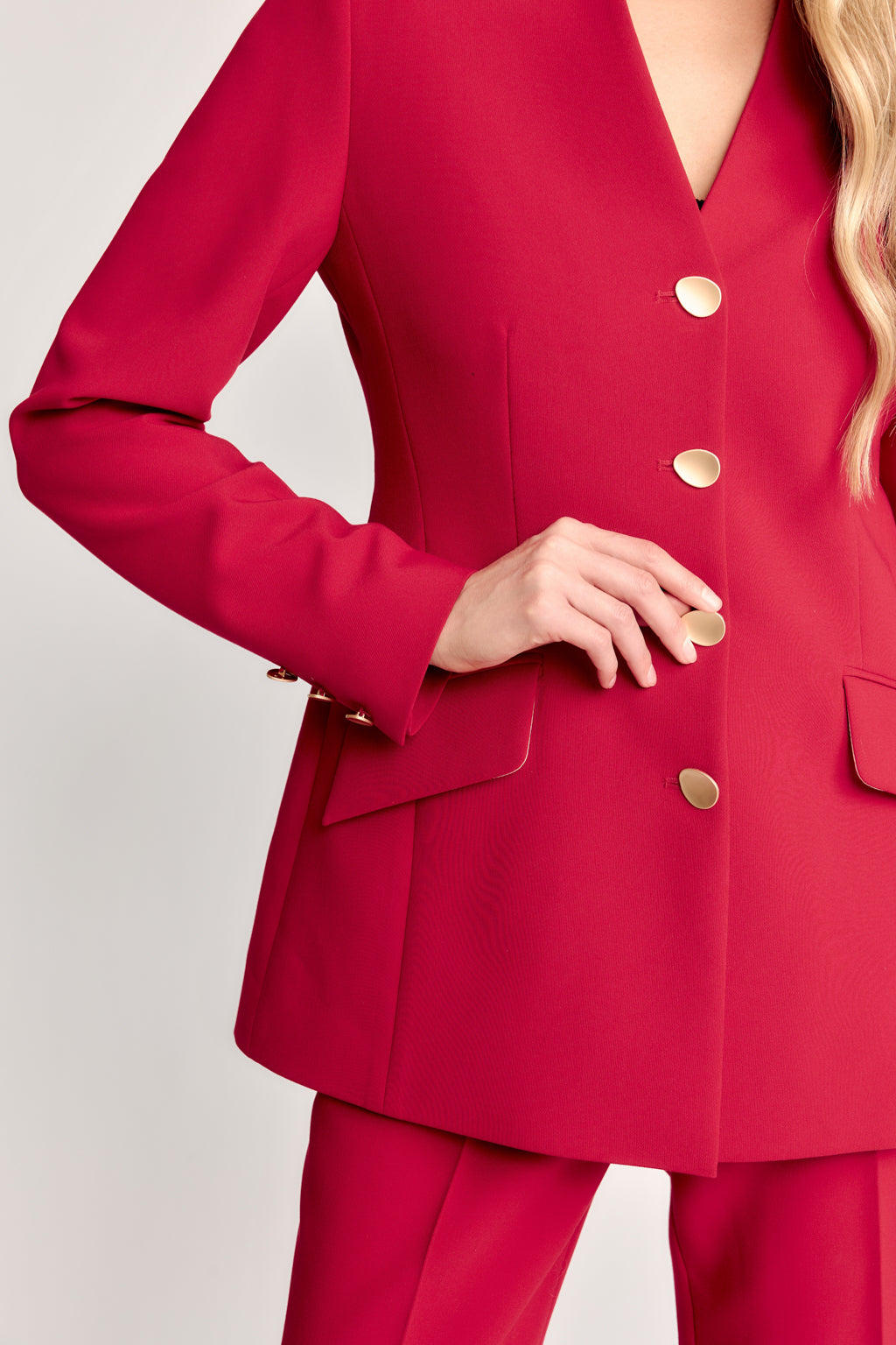 Red suit with gold buttons on a plain background