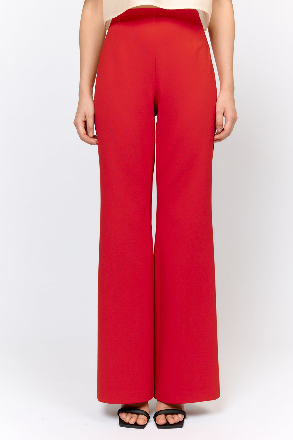 Red wide-leg pants worn by a person on a white background