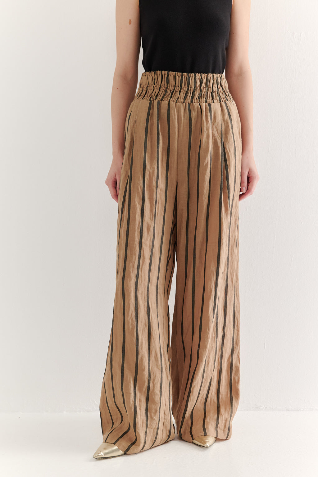 Striped pants worn by a person on a white background