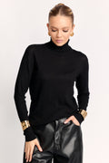 Woman wearing a black turtleneck sweater and black leather pants on a white background