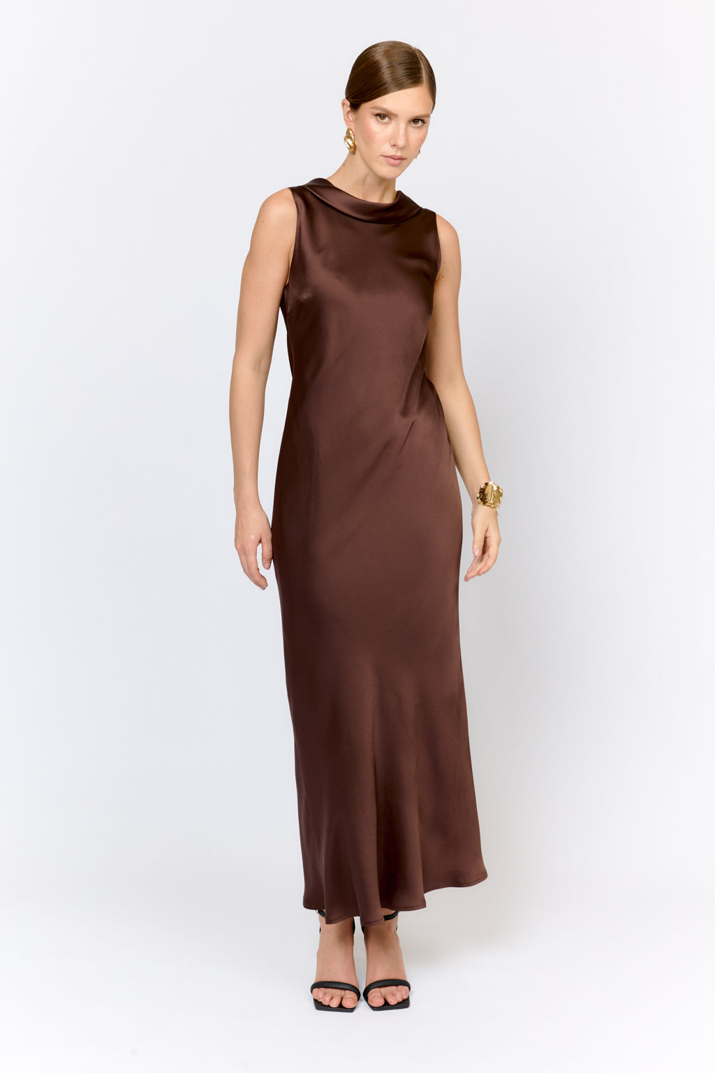 Woman wearing a brown dress on a white background