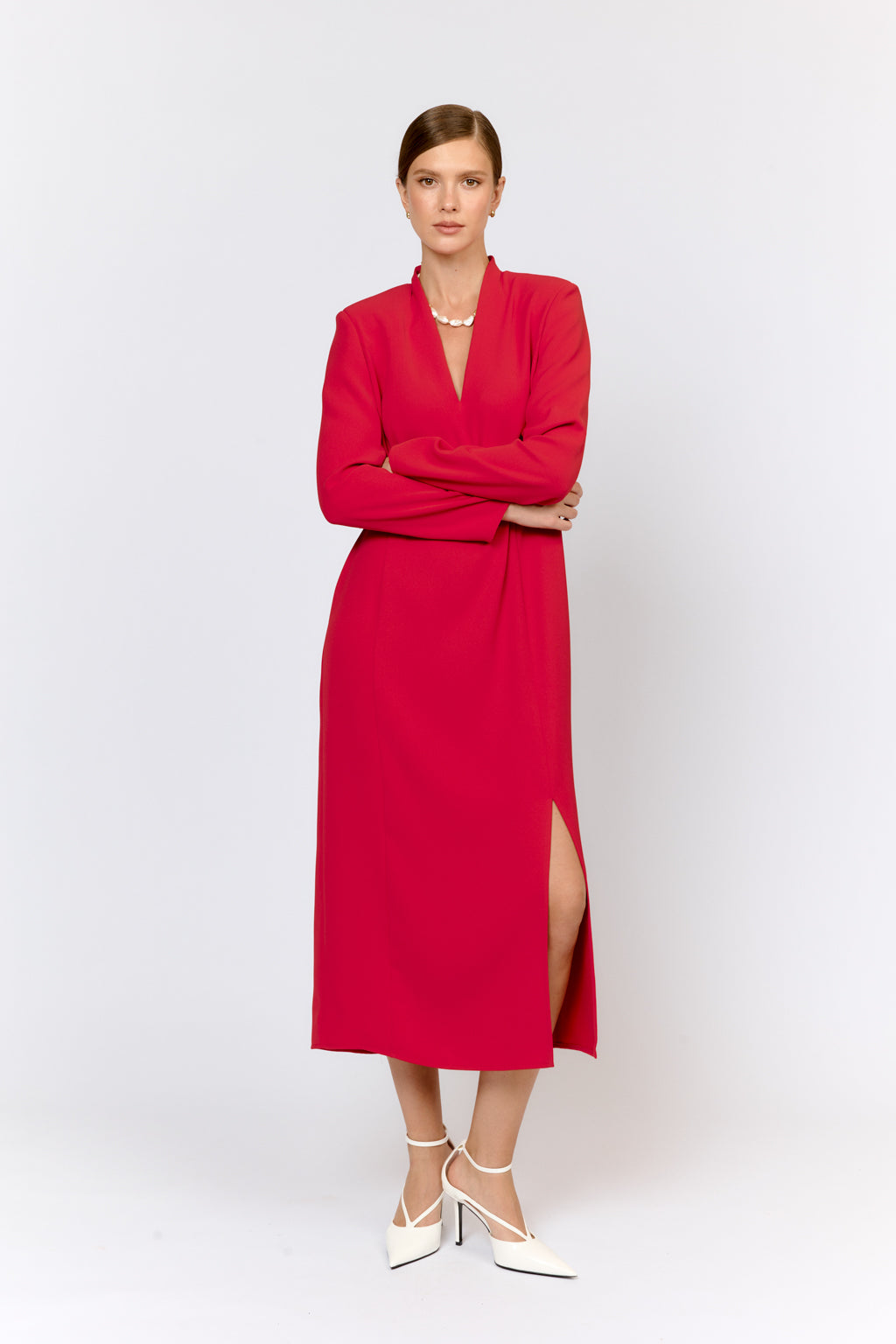 Woman wearing a red dress with a white background