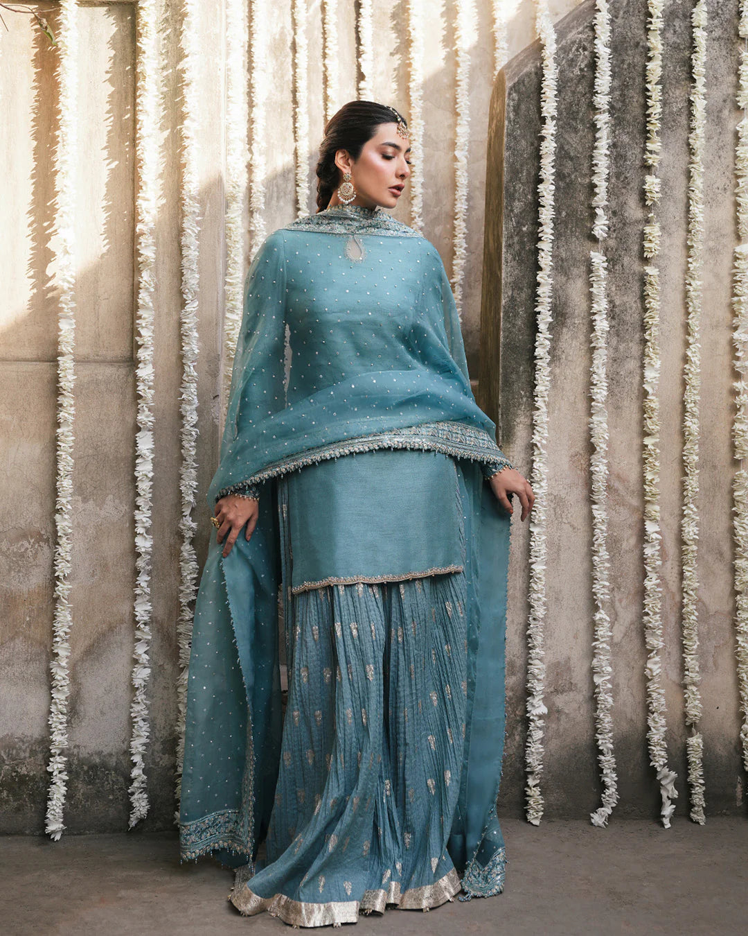 tisha-regal-turquoise-sharara-set-with-scalloped-embroidered-dupatta-borders-standing-view-ayra