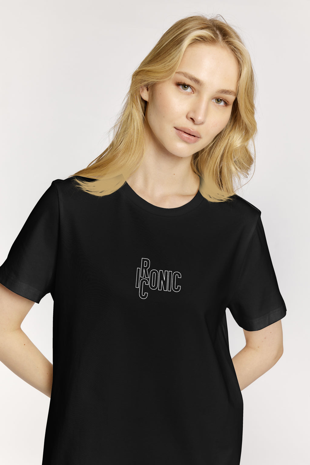 Woman wearing a black t-shirt with a logo on a white background