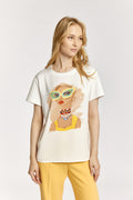 Woman wearing a white t-shirt with a graphic design on a plain background