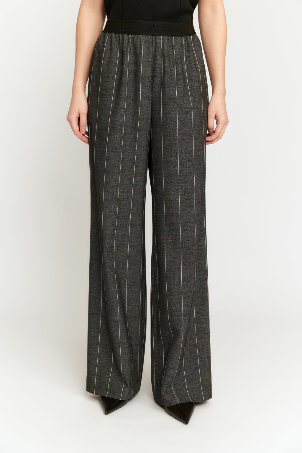 Person wearing gray pinstripe pants on a white background