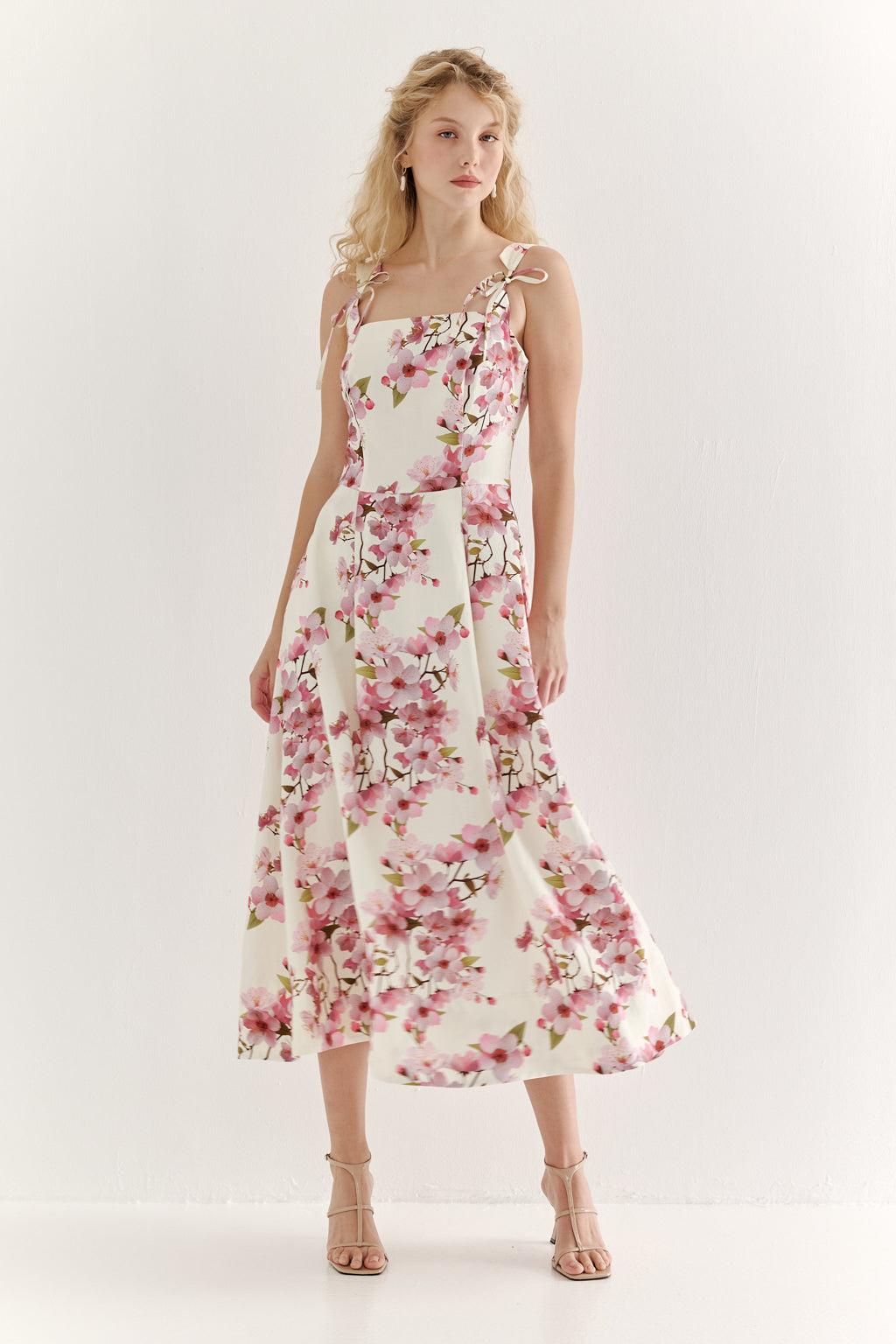 Woman wearing a floral dress on a white background