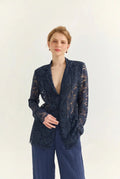 Ayra Store based in New York united states of America Woman wearing AYRA Vinyl Corded Lace Jacket with notched lapel and scalloped hem paired with fluid navy blue trousers