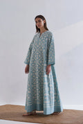 A floor-length cerulean blue Chanderi dress featuring ivory geometric hand-cut appliqué along the hemline and sleeves.