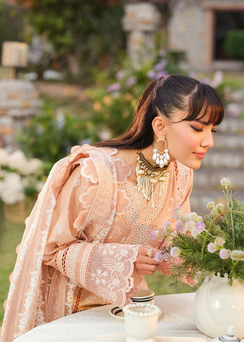 Woman in a pink traditional outfit holding flowers outdoors