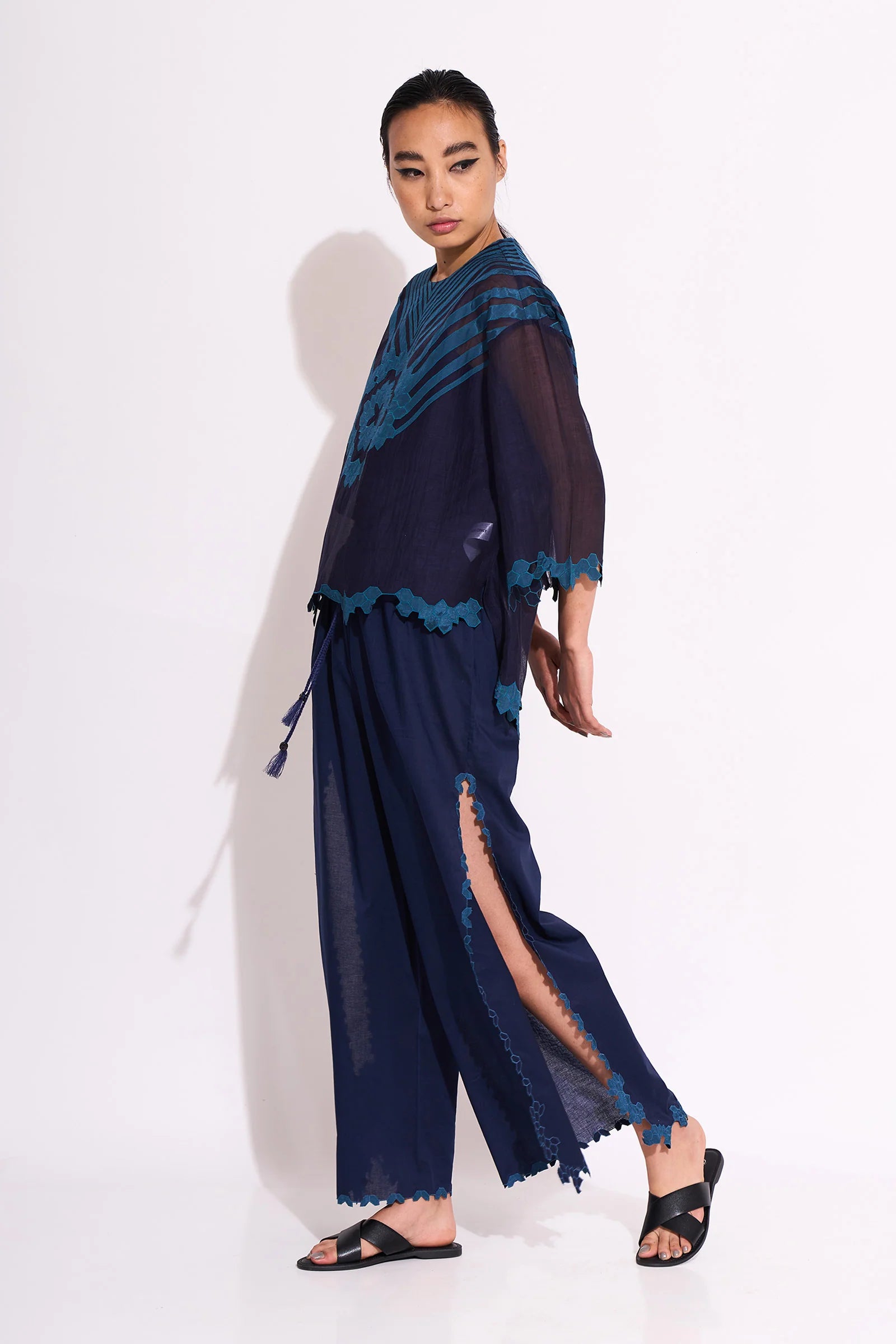 A navy blue Cotton Silk Chanderi shirt with teal geometric hand-cut appliqué on the front chest and back, featuring a pleated back design and scalloped edges.