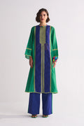 A model in a green and navy blue colour-blocked kameez featuring yellow geometric hand-cut appliqué and vertical stripe details.