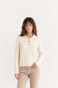 Woman wearing luxury ivory cotton polo jumper styled with tailored trousers - AYRA Store quiet luxury knitwear