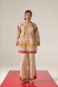 An asian model wearing white Cotton Silk Chanderi shirt featuring a drop-shoulder silhouette with detailed geometric cutwork panels and tonal threadwork along the sleeves and back.
