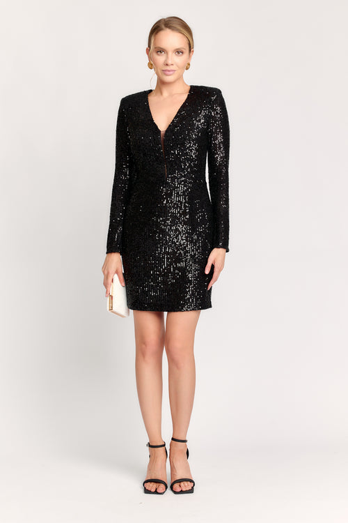 Black sequin dress worn by a model on a white background