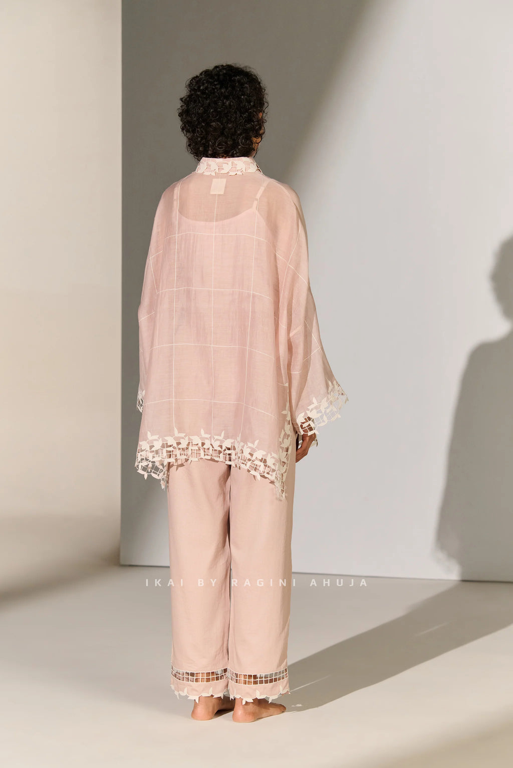 A dusty mauve Cotton Silk Chanderi kaftan shirt featuring geometric floral cutwork panels and tonal appliqué on the shoulders and back.