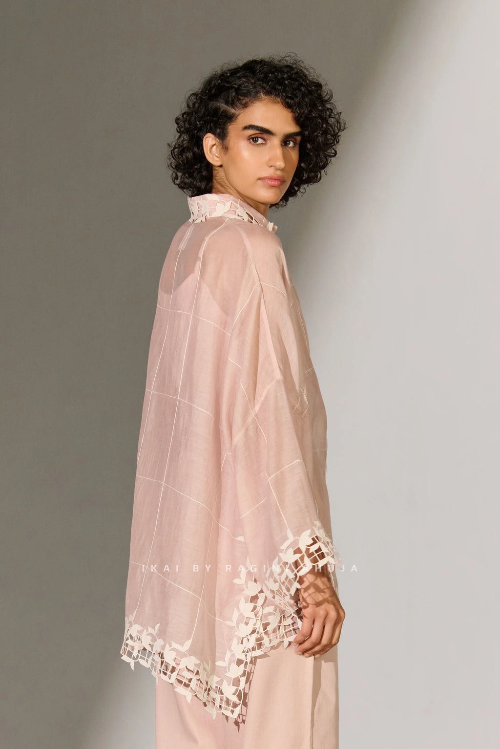 A dusty mauve Cotton Silk Chanderi kaftan shirt featuring geometric floral cutwork panels and tonal appliqué on the shoulders and back.