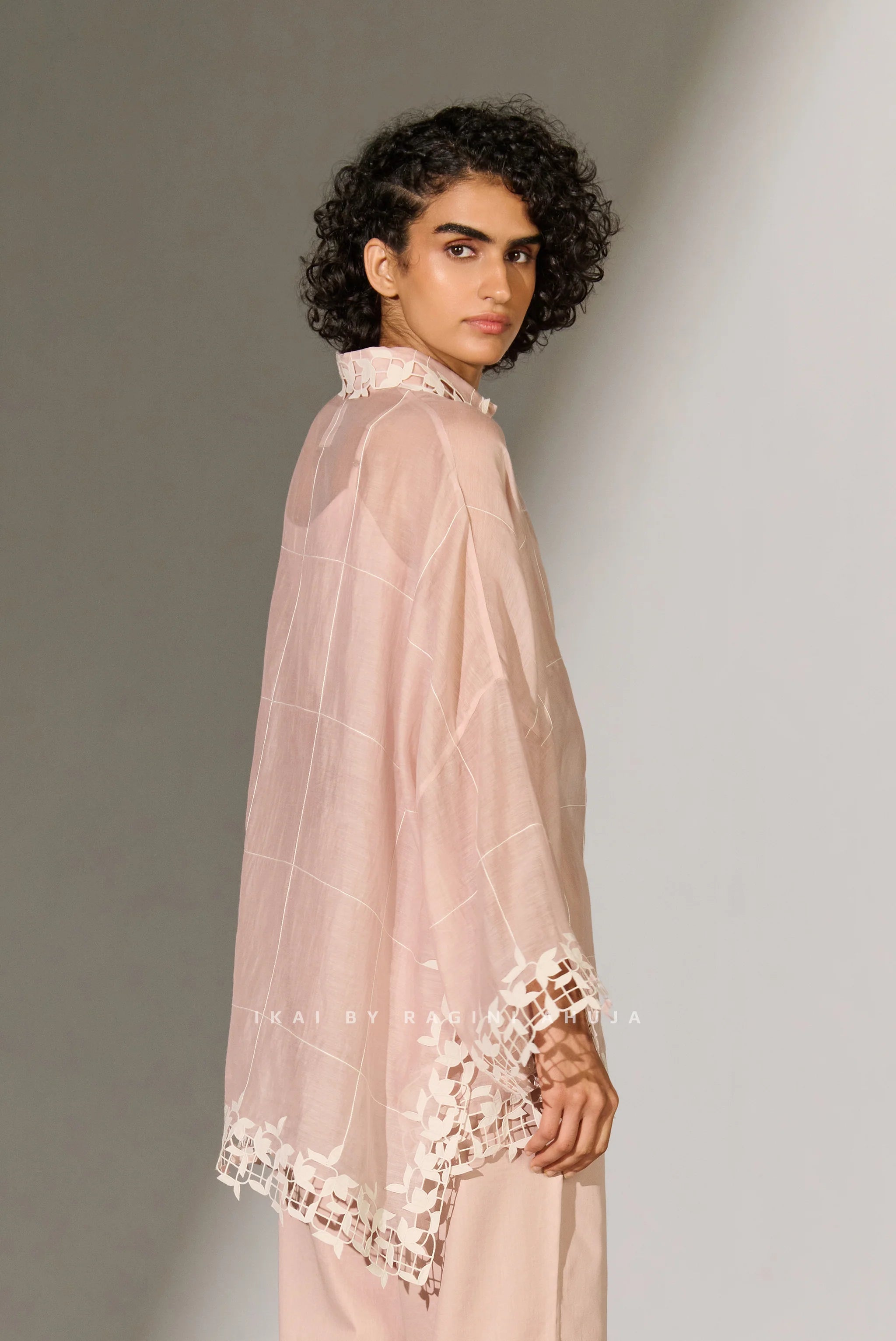 A dusty mauve Cotton Silk Chanderi kaftan shirt featuring geometric floral cutwork panels and tonal appliqué on the shoulders and back.