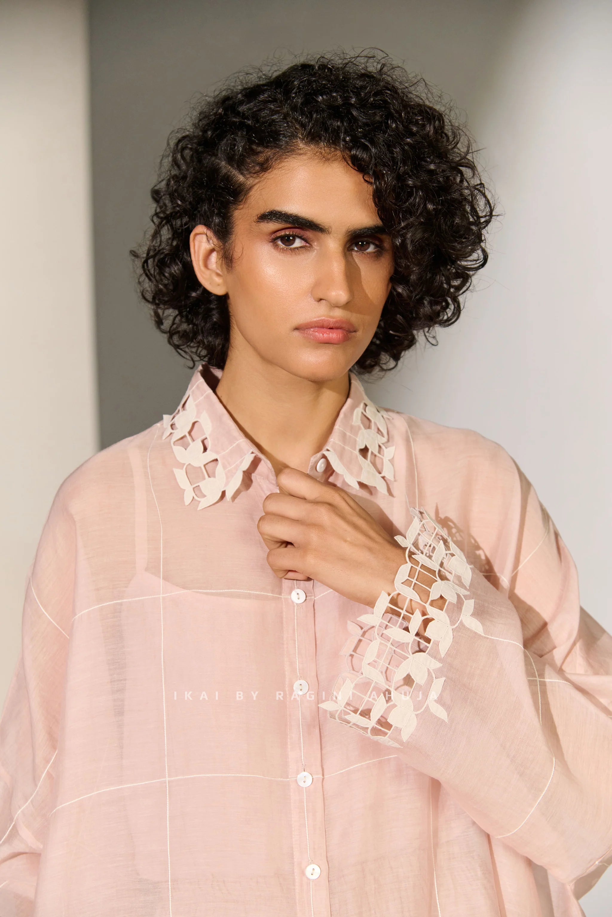 A dusty mauve Cotton Silk Chanderi kaftan shirt featuring geometric floral cutwork panels and tonal appliqué on the shoulders and back.