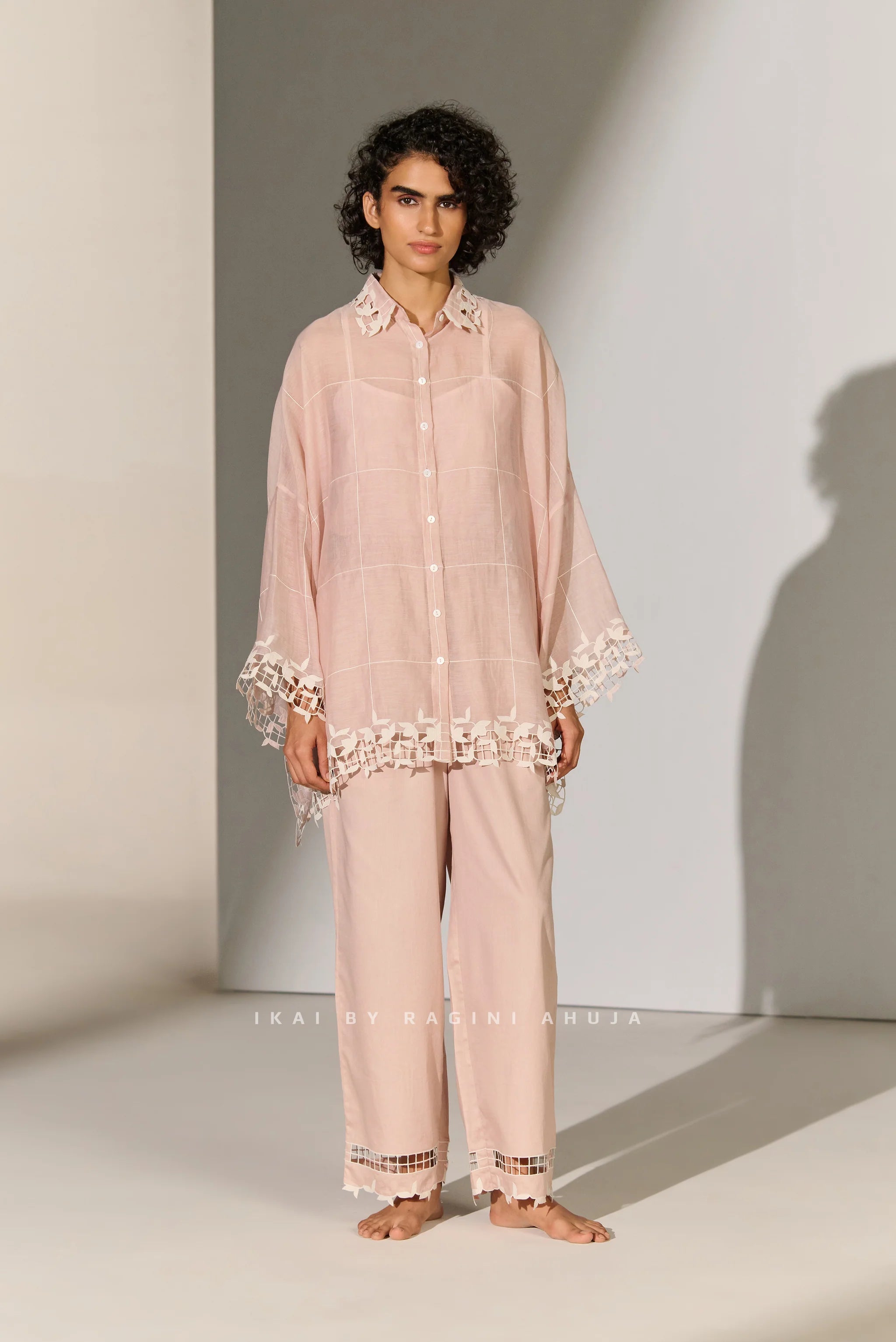 A dusty mauve Cotton Silk Chanderi kaftan shirt featuring geometric floral cutwork panels and tonal appliqué on the shoulders and back.