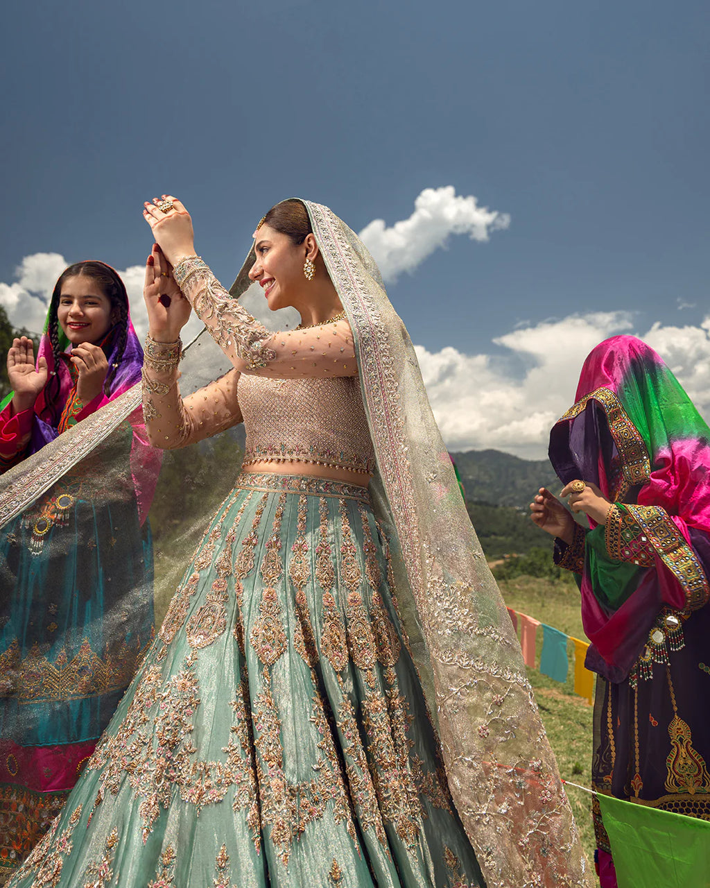 Woman in traditional embroidered outfit with mountains and blue sky in the background