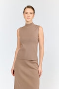 Woman wearing a brown sleeveless top and skirt set on a white background