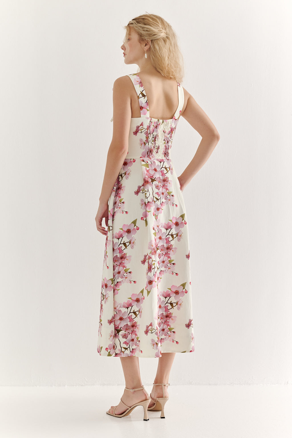 Woman wearing a floral dress on a white background