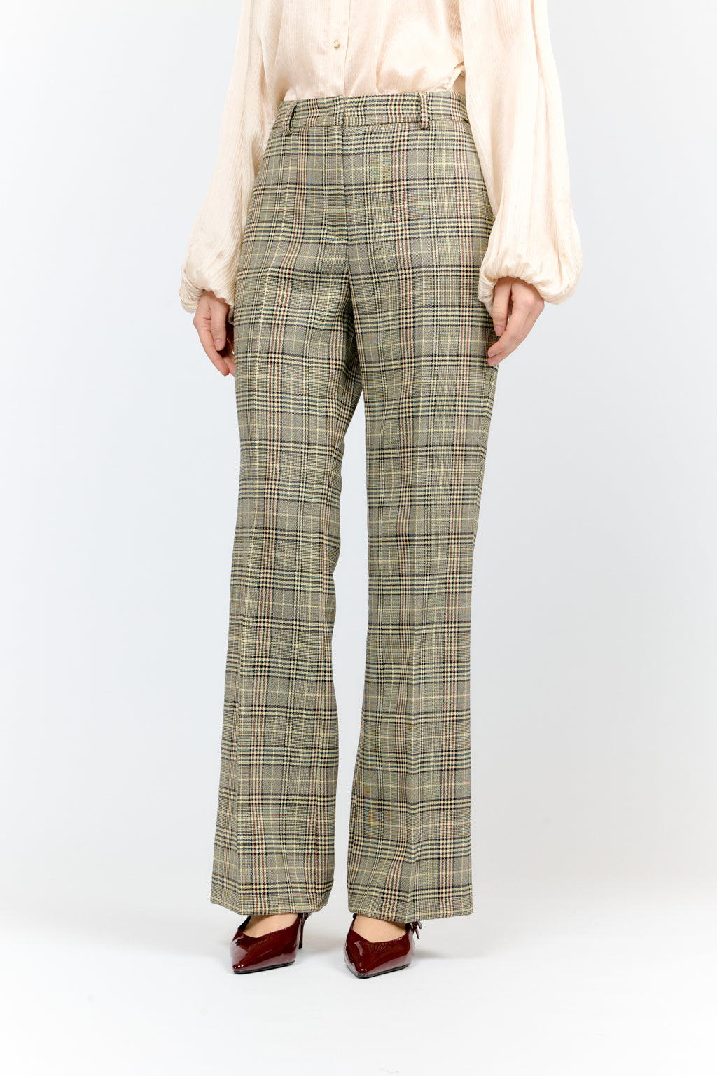 Person wearing plaid pants on a white background
