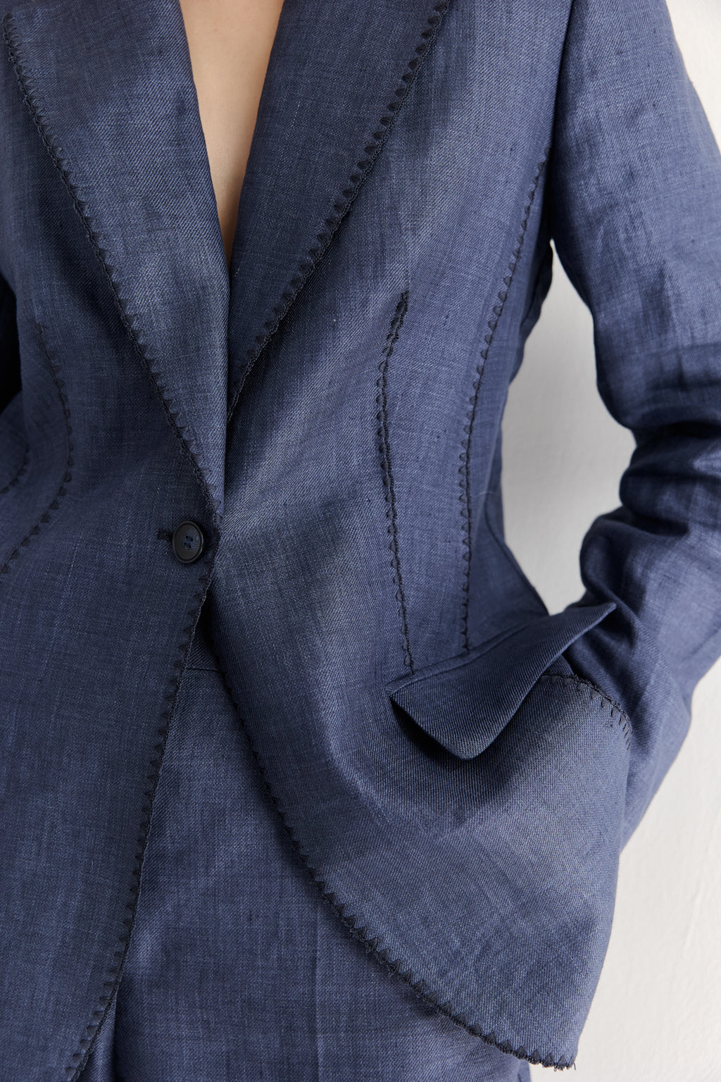 Close-up of a blue suit jacket with a blurred background