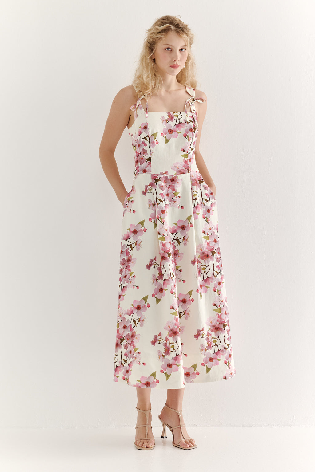 Woman wearing a floral dress on a white background