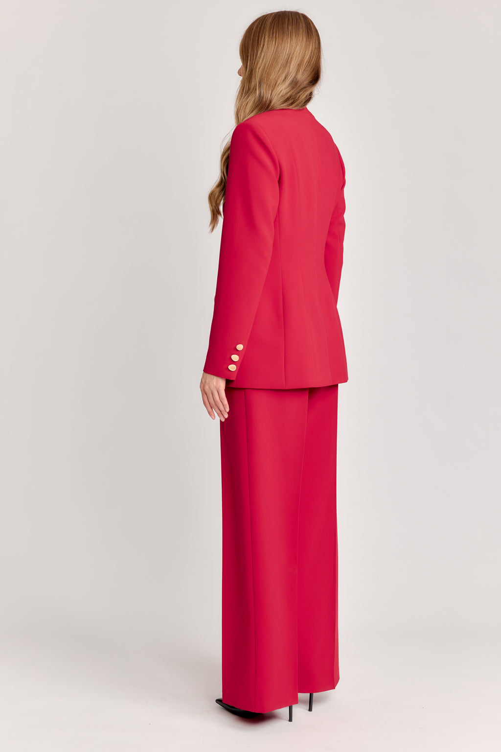 Woman wearing a red suit on a white background