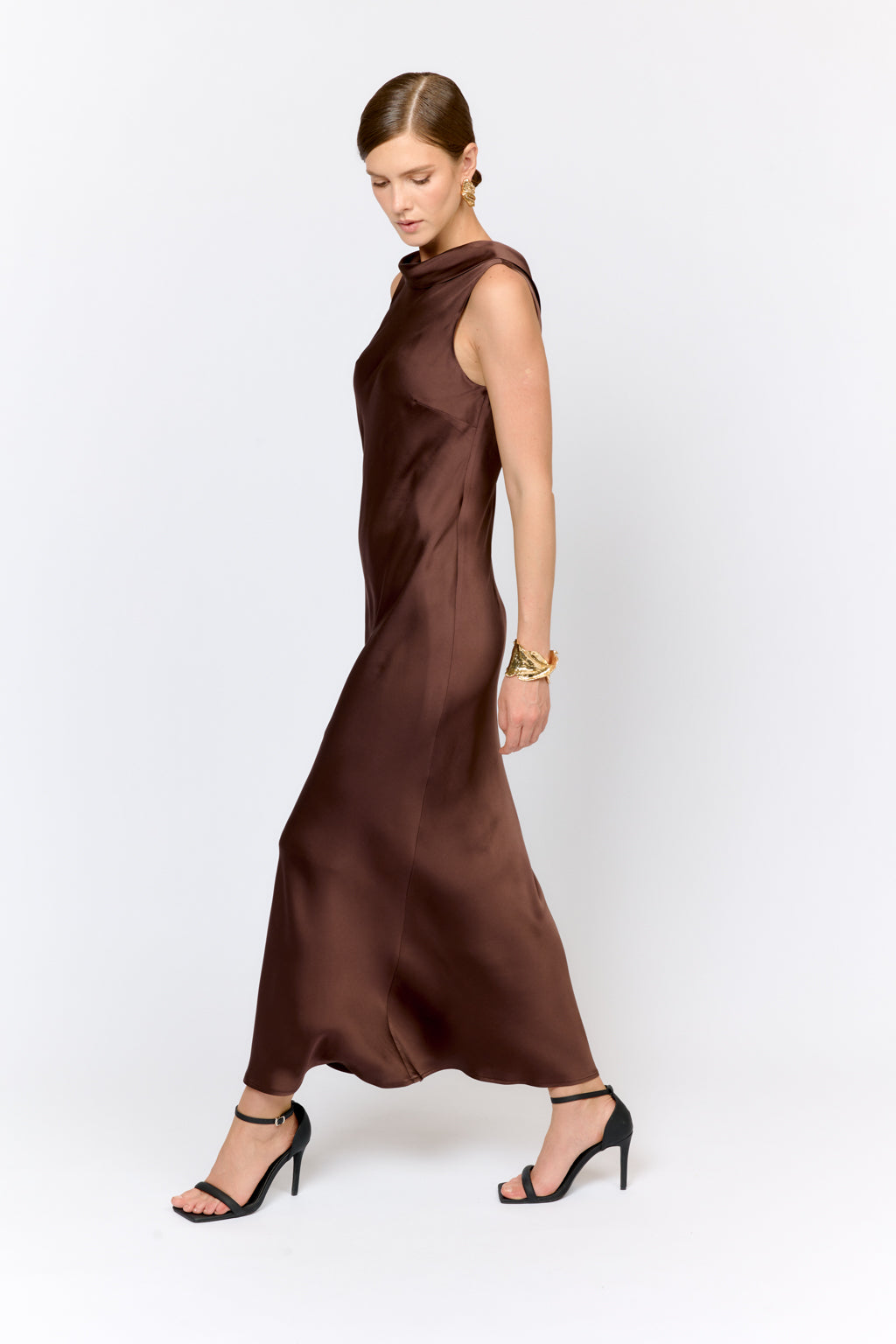 Woman wearing a brown dress on a white background
