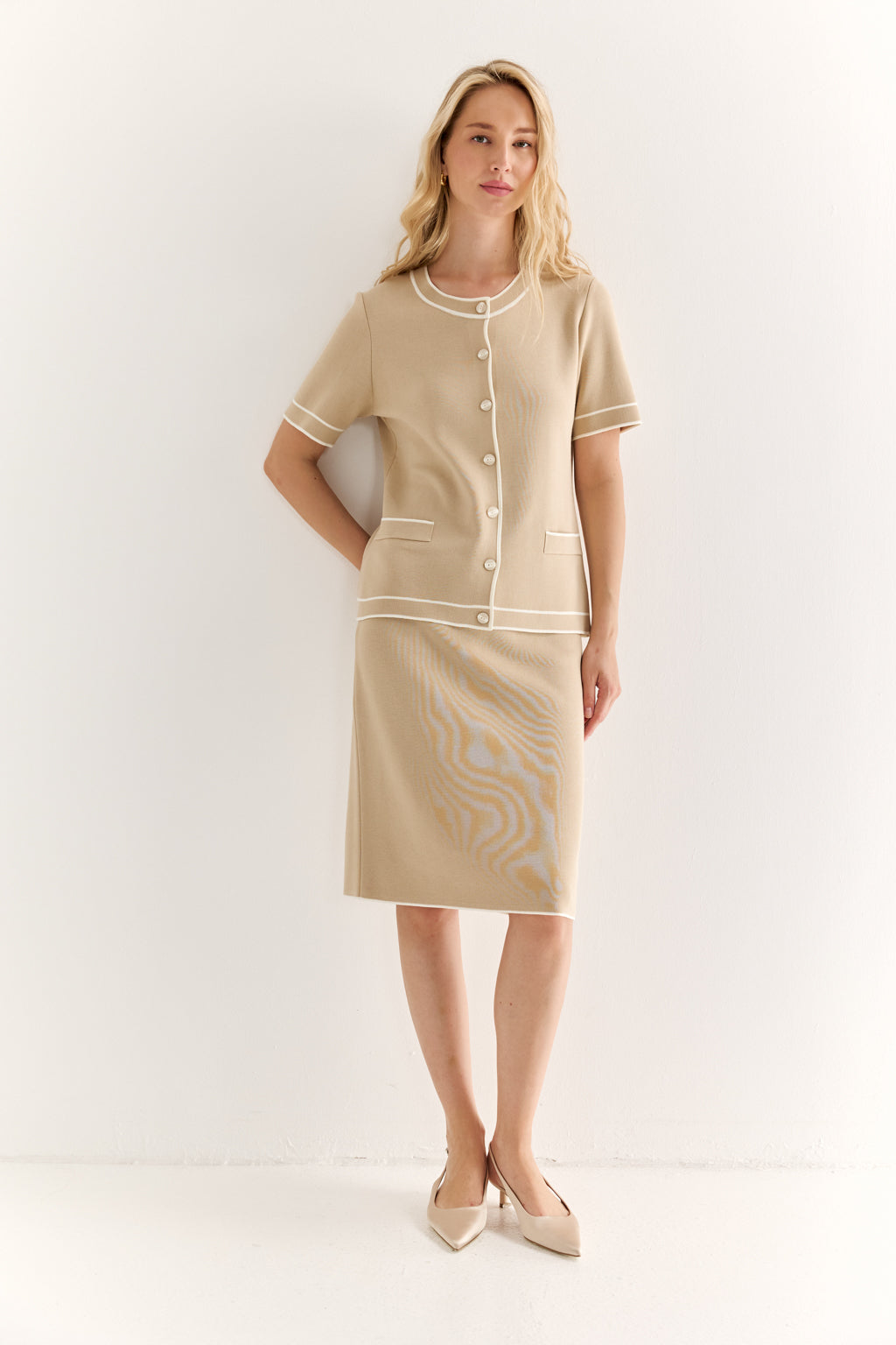 Woman wearing a beige dress with a white background