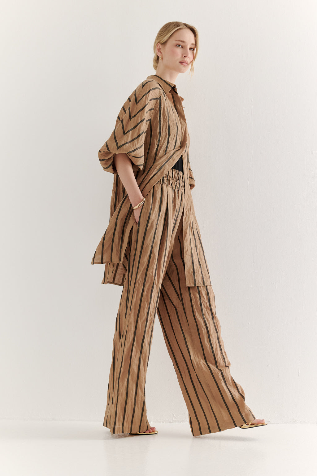 Woman wearing a striped outfit on a white background