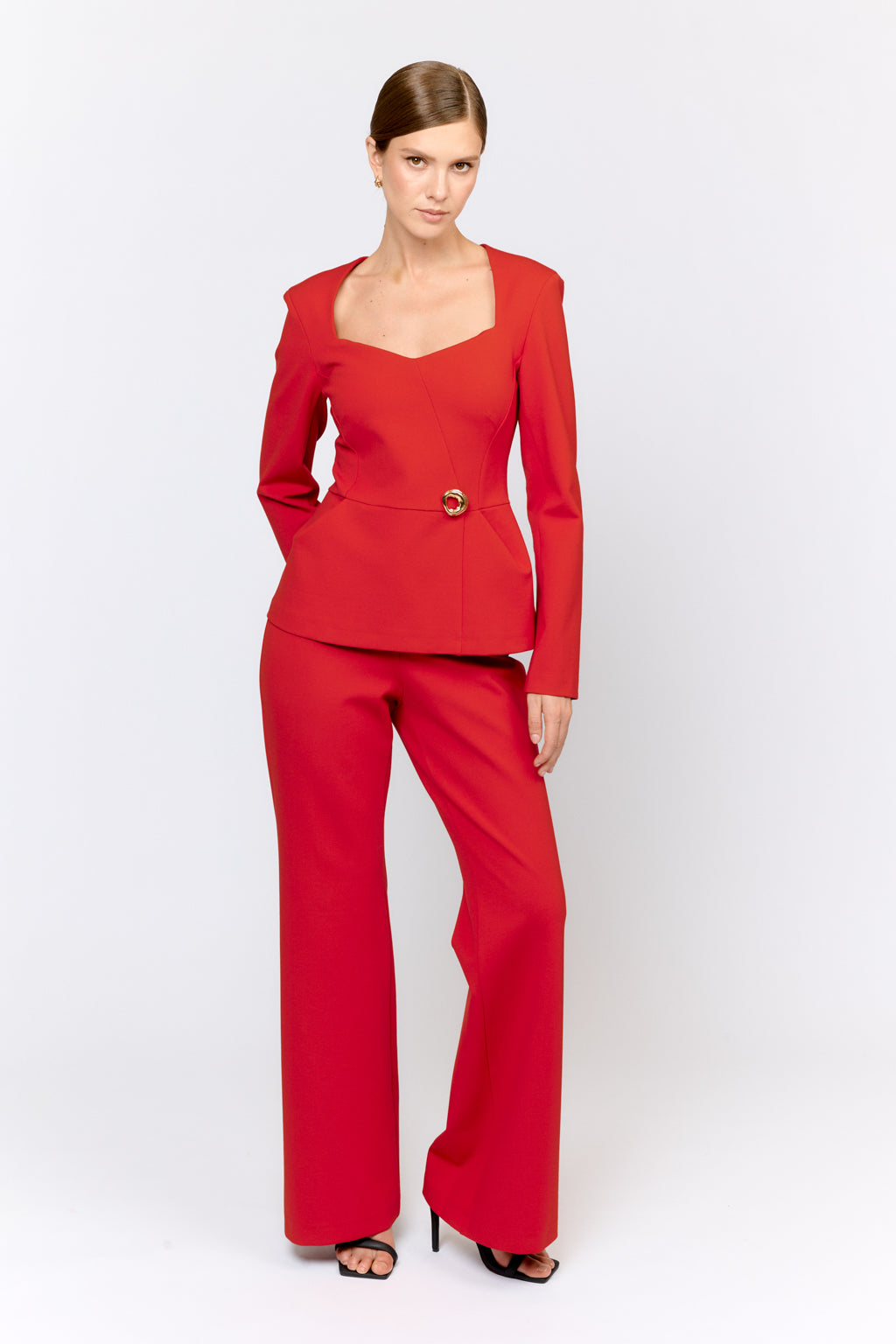 Woman wearing a red outfit with a white background
