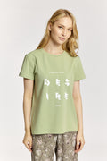 Woman wearing a light green t-shirt with text on a white background