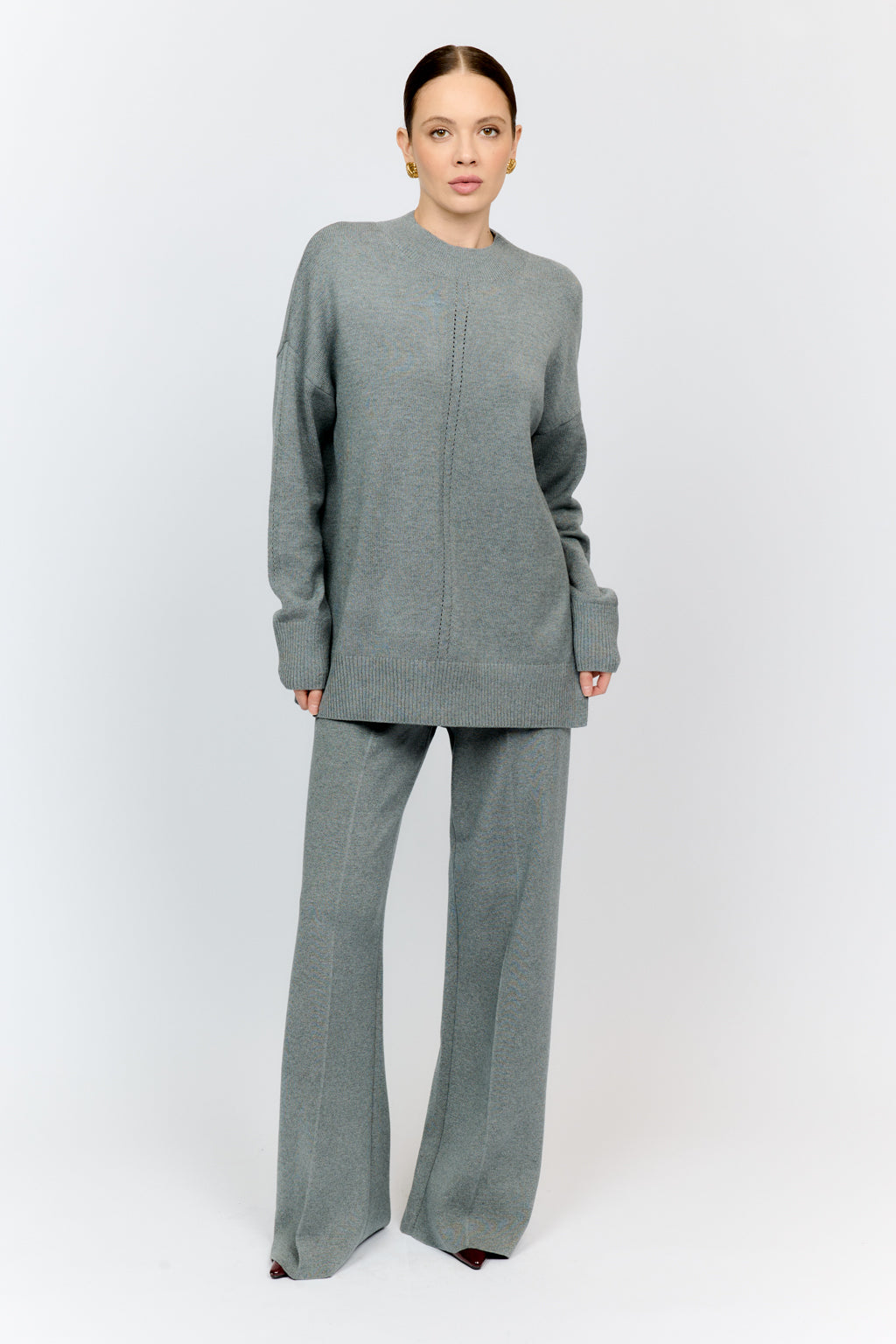 Woman wearing a gray outfit on a white background