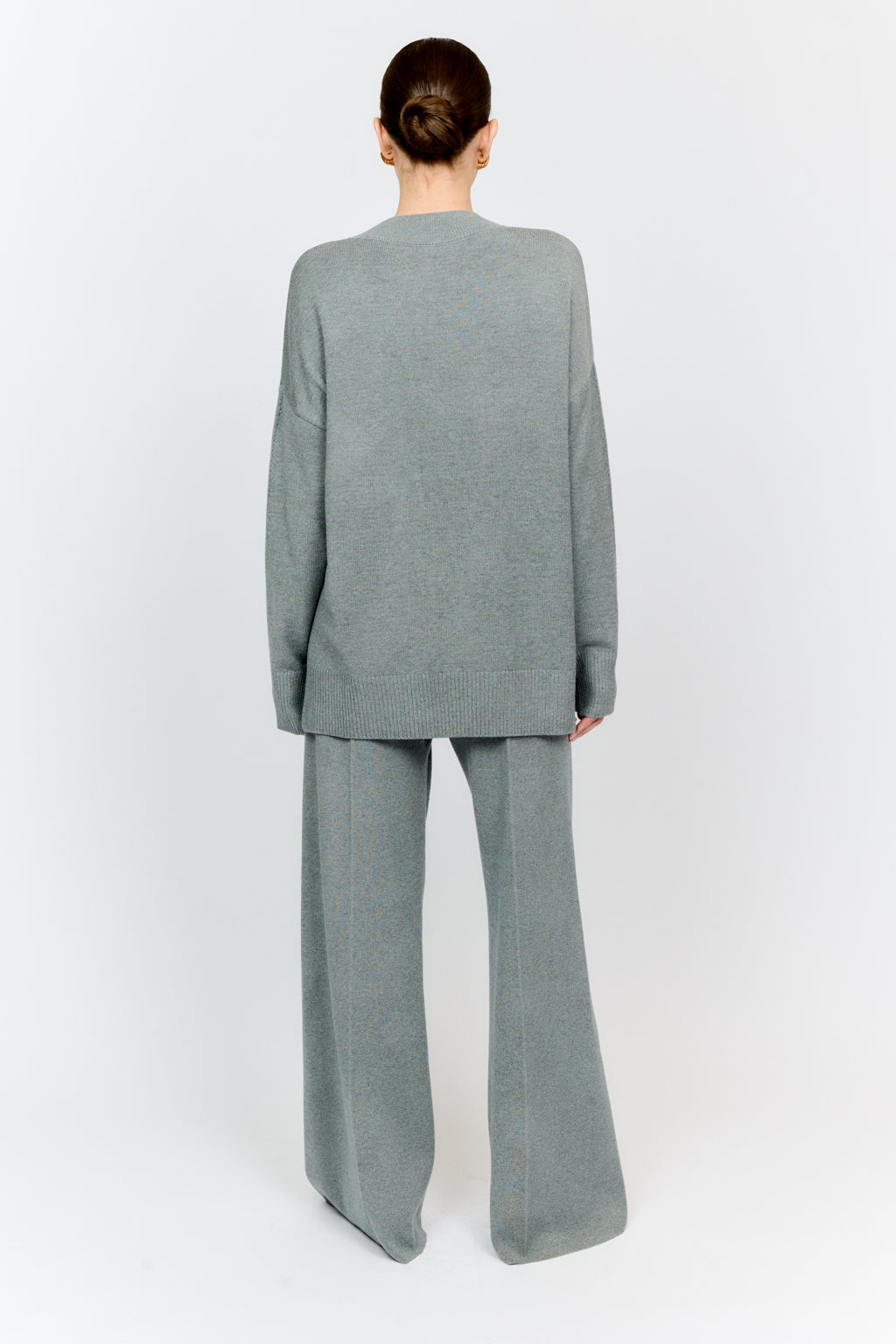 Person wearing a gray suit on a white background