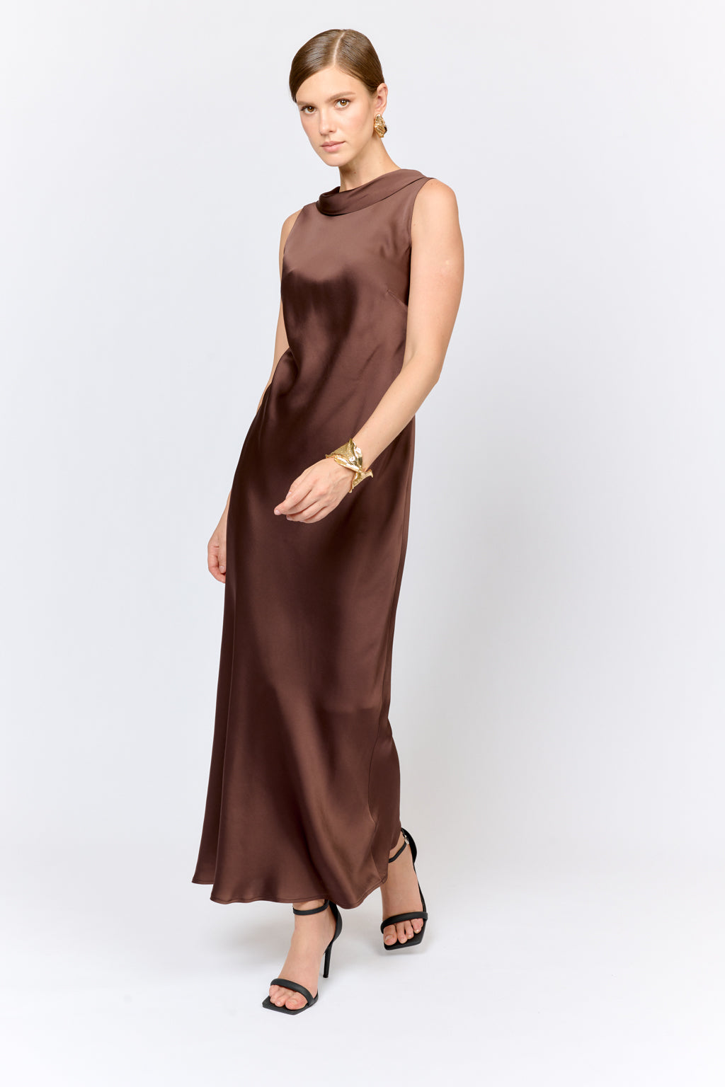 Woman wearing a brown sleeveless dress on a white background