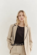 Beautiful Woman wearing AYRA STORE Sand Piped Safari Luxury Blazer in pinstriped lyocell-linen melange with dark contrasting piped trim
